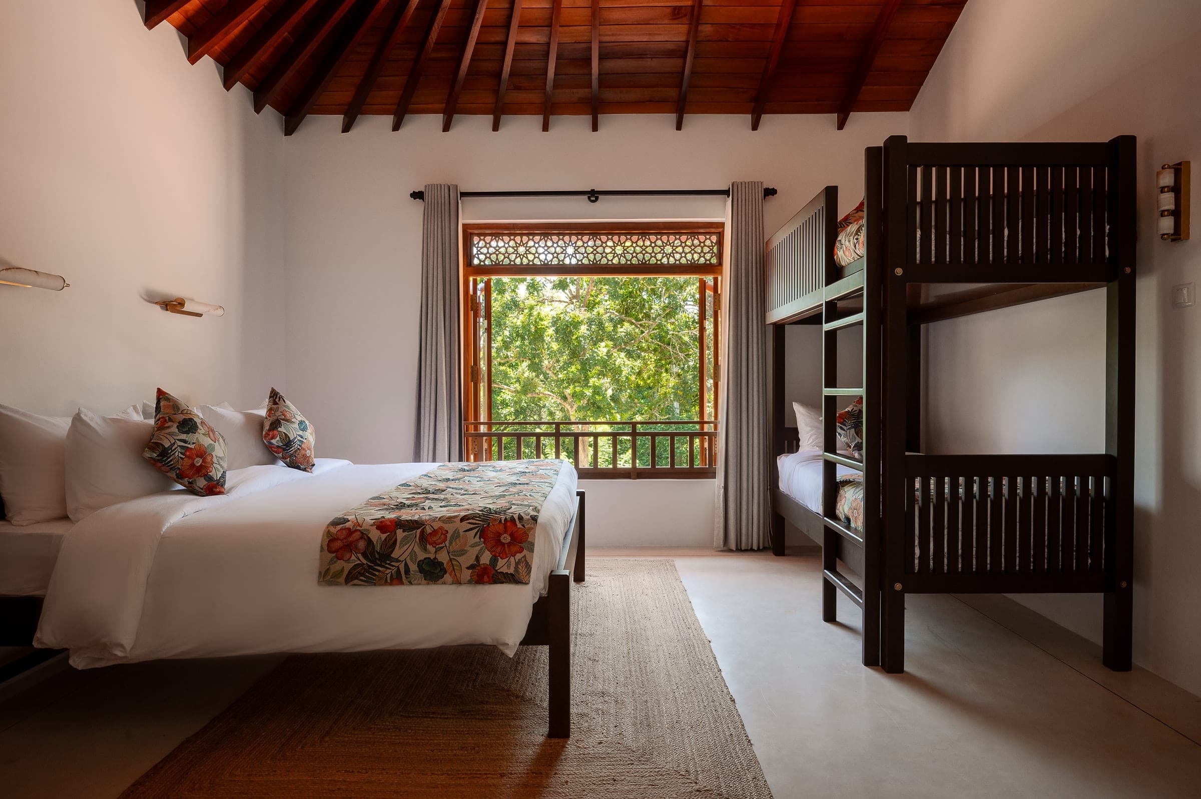 Bedroom Four, the family room: a queen bed and bunk beds for two children under the vaulted ceiling