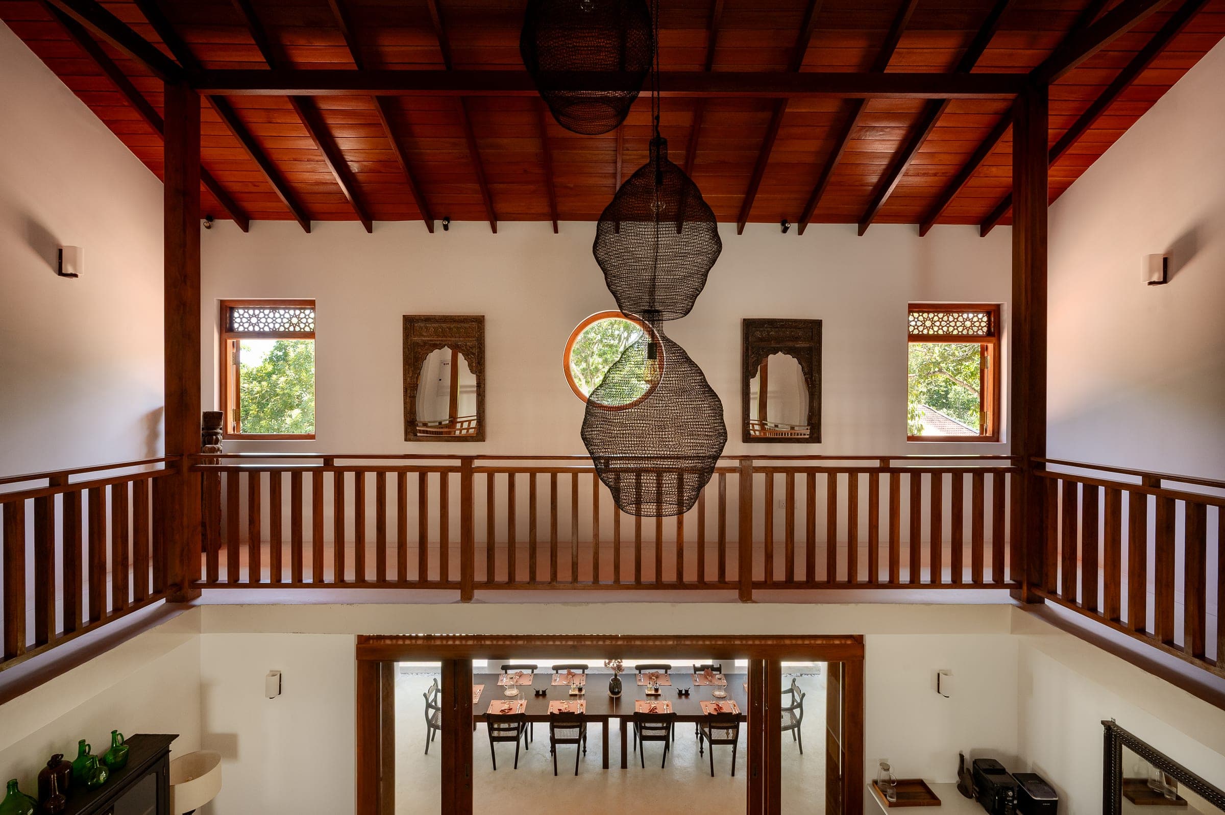 Looking down from the gallery at Kottamba Kanda to the dining verandah, the table laid for dinner